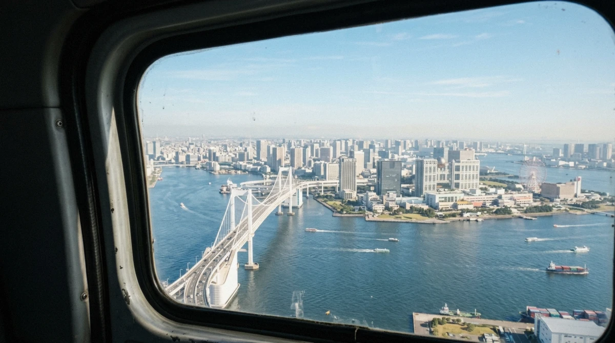 Rainbow Bridge, Odaiba and Tokyo Bay seen through the cabin window on a Tokyo helicopter tour, the view your fare pays for